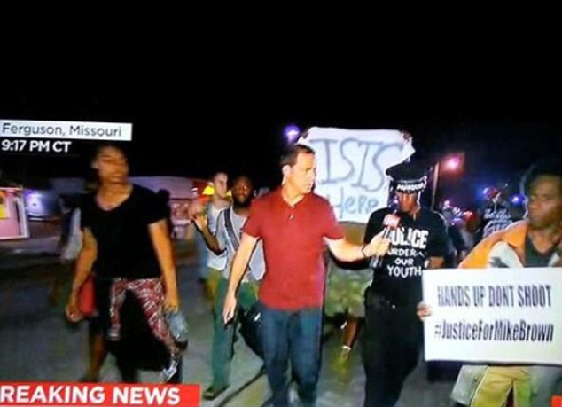 'Chilling': Footage purportedly from a CNN live stream of the protests appeared to show one young demonstrator marching along a street holding a sign reading 'ISIS is here'
